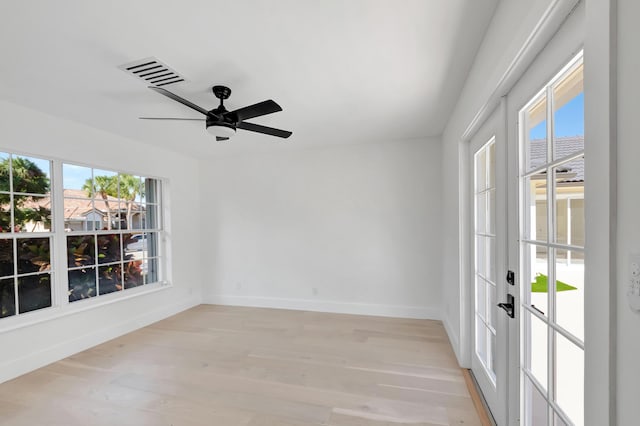 spare room featuring ceiling fan and light wood-type flooring