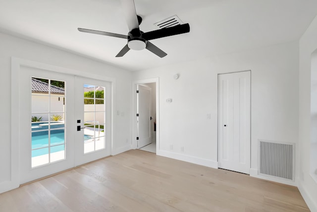 unfurnished room with french doors, ceiling fan, and light hardwood / wood-style floors