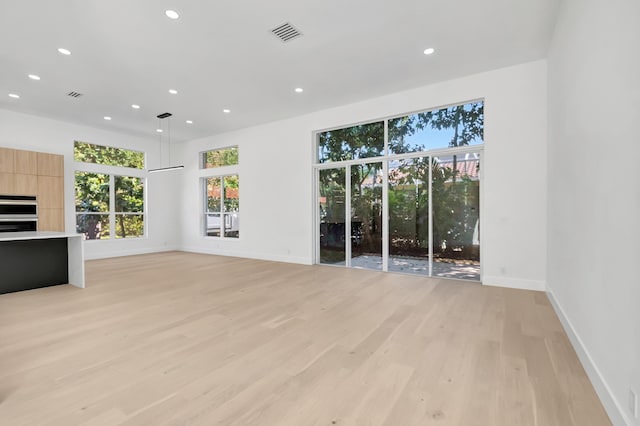 unfurnished living room featuring light hardwood / wood-style flooring