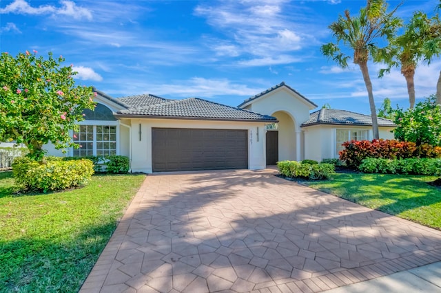 view of front of home featuring a garage and a front lawn