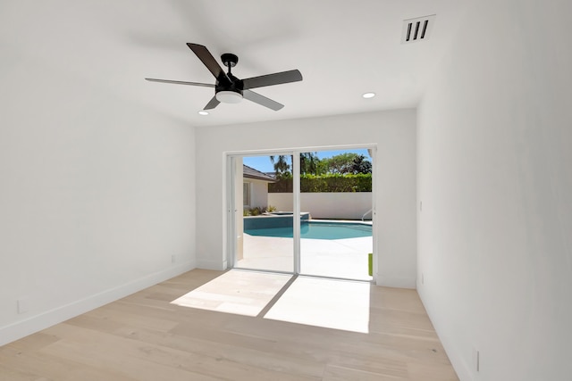 empty room featuring ceiling fan and light hardwood / wood-style floors