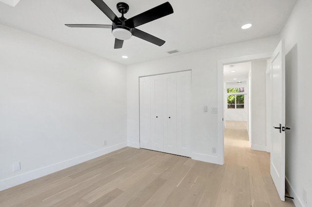 unfurnished bedroom with a closet, ceiling fan, and light wood-type flooring