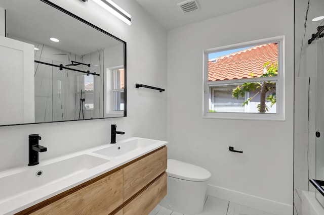 bathroom featuring a shower with door, vanity, and toilet