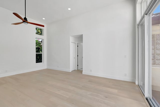 unfurnished room featuring high vaulted ceiling, light hardwood / wood-style floors, and ceiling fan