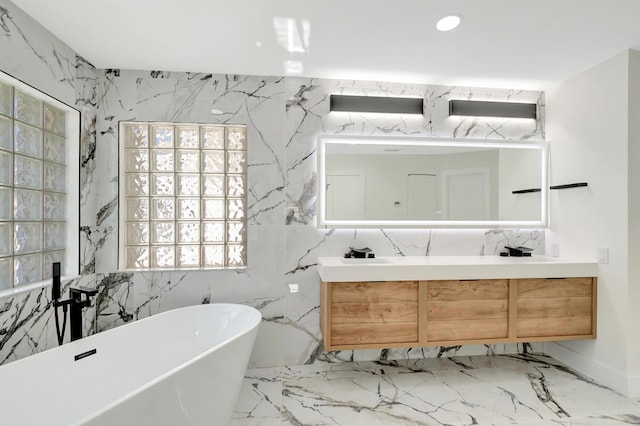 bathroom with vanity and a bath