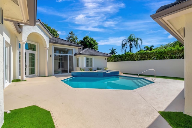 view of swimming pool featuring a patio and an in ground hot tub