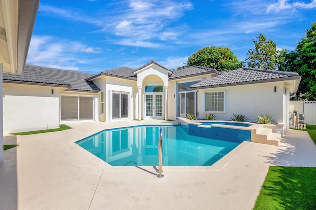 view of swimming pool featuring french doors, an in ground hot tub, and a patio area