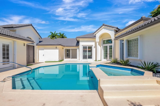 view of pool featuring french doors and an in ground hot tub