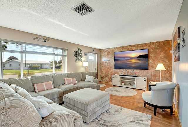 living room with hardwood / wood-style floors and a textured ceiling