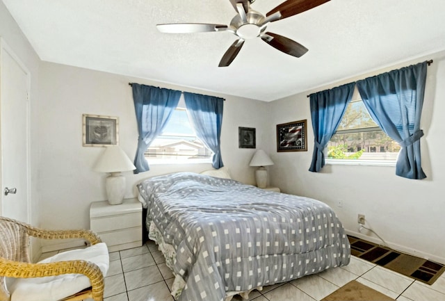 tiled bedroom featuring ceiling fan