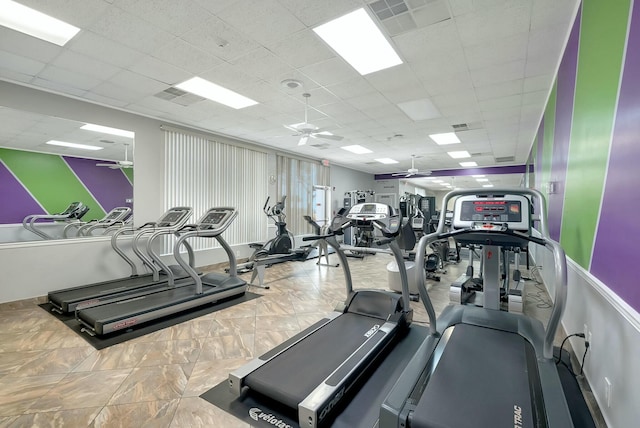 workout area featuring a paneled ceiling and ceiling fan