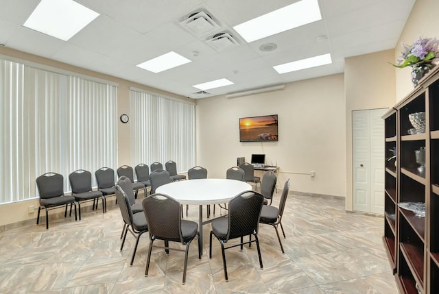 dining space with a drop ceiling