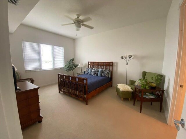 bedroom with light colored carpet and ceiling fan