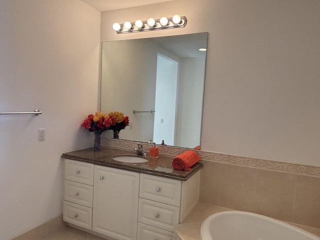 bathroom with vanity and a tub