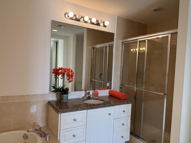 bathroom featuring vanity and a shower with shower door