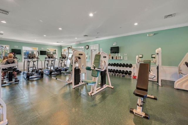 workout area featuring crown molding