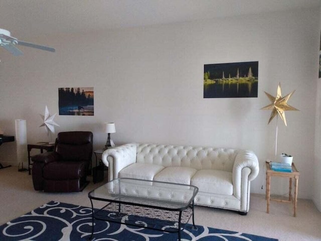 carpeted living room with ceiling fan