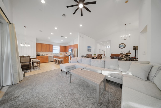 living room featuring ceiling fan with notable chandelier, high vaulted ceiling, and light tile patterned floors