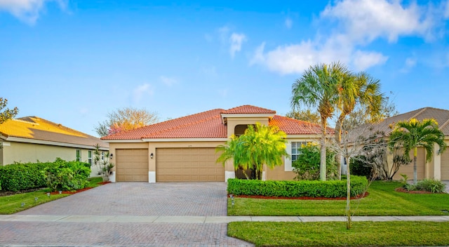 mediterranean / spanish-style home with a garage and a front yard