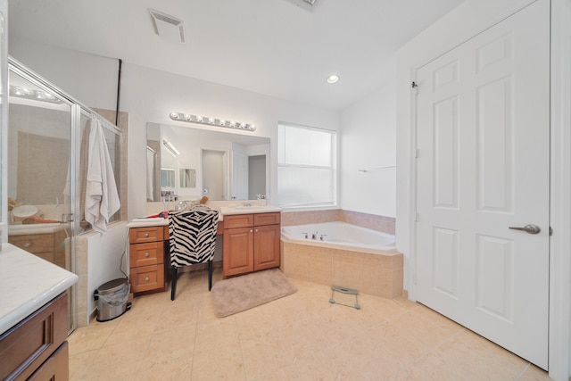 bathroom featuring tile patterned floors, vanity, and shower with separate bathtub