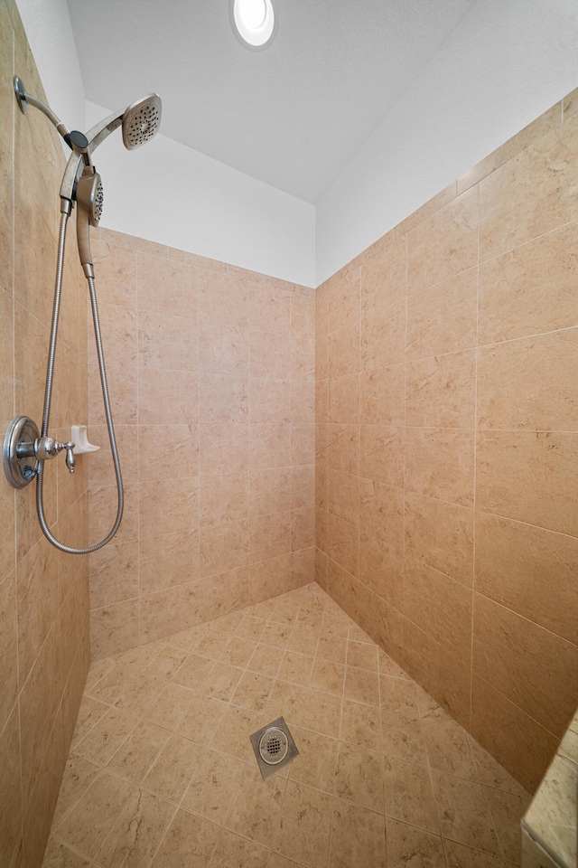 bathroom with tiled shower