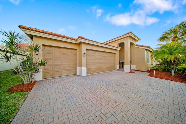 mediterranean / spanish-style house with a garage