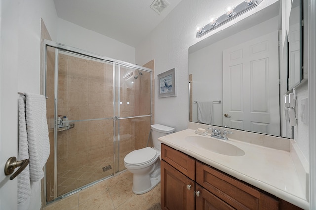 bathroom featuring vanity, tile patterned floors, toilet, and walk in shower