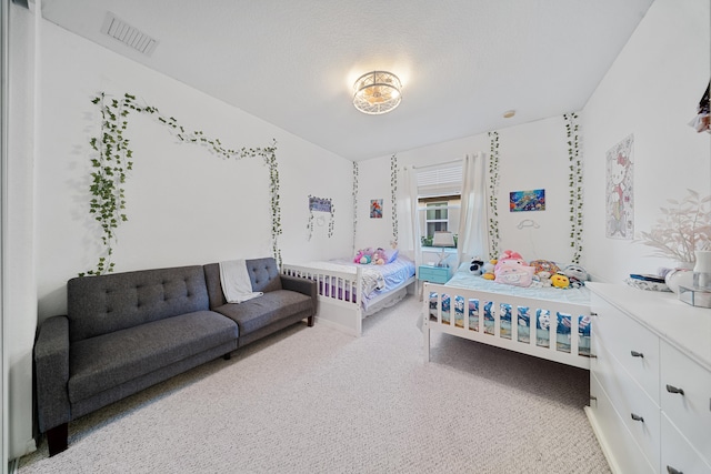 carpeted bedroom with a textured ceiling