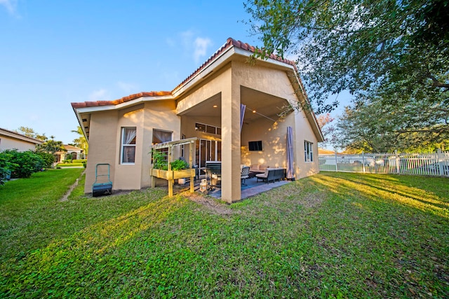 back of house with a yard and a patio area