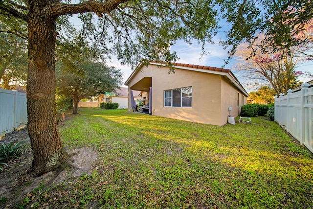 rear view of house with a yard