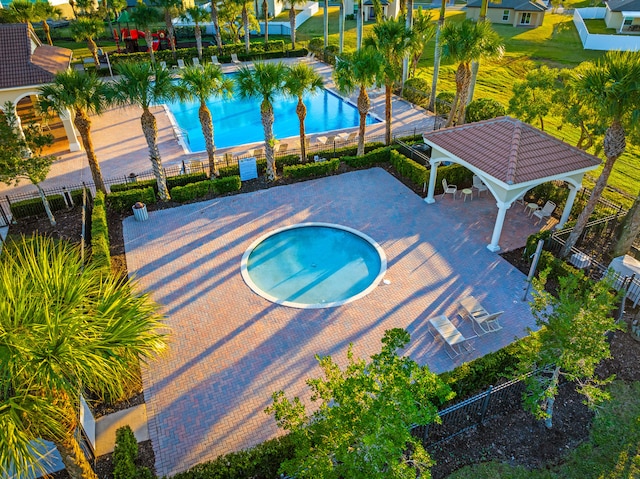 view of swimming pool with a gazebo, a community hot tub, and a patio