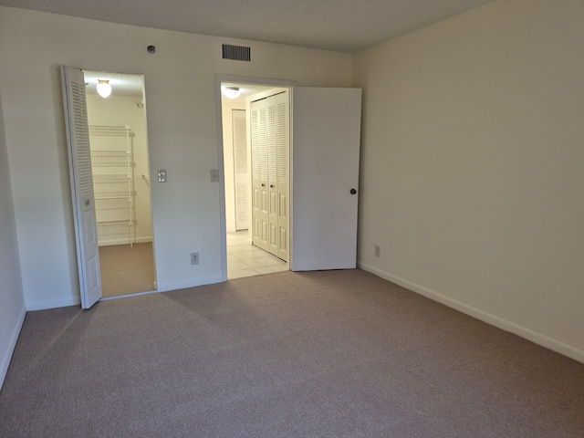 unfurnished bedroom with light carpet