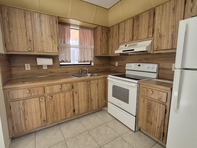 kitchen with light tile patterned flooring, sink, backsplash, and white appliances