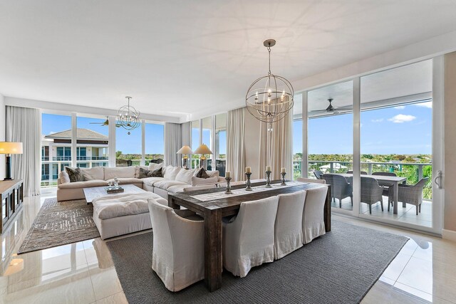 dining space with a wealth of natural light, a notable chandelier, and light tile patterned floors