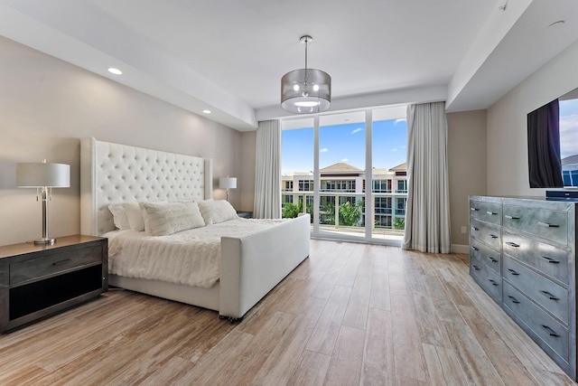 bedroom with access to outside and light wood-type flooring