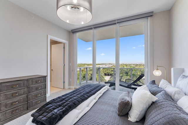 bedroom with floor to ceiling windows, light carpet, and access to exterior