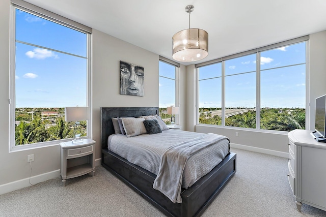 carpeted bedroom featuring multiple windows