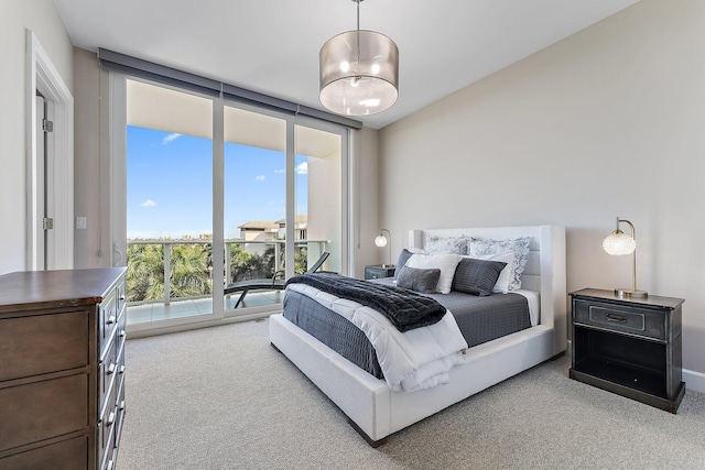 bedroom featuring light colored carpet, floor to ceiling windows, and access to exterior