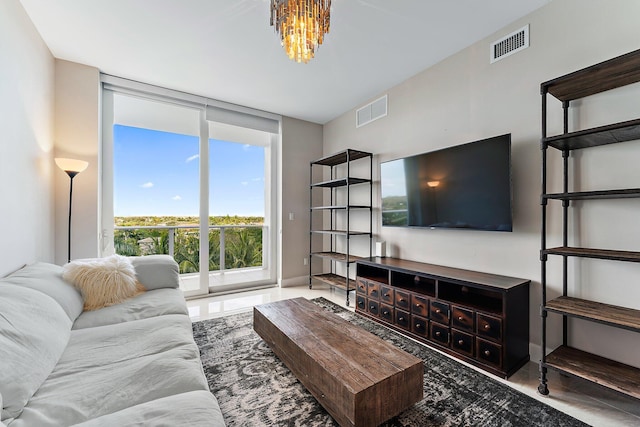 living room with floor to ceiling windows and a notable chandelier