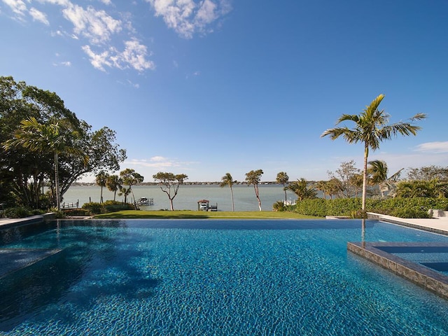 view of swimming pool featuring a water view