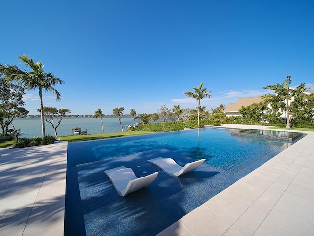 view of pool with a water view and a patio