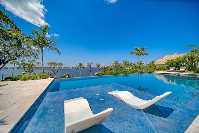 81 S River Rd, Stuart, FL 34996 - view of swimming pool featuring a patio and a pool with connected hot tub