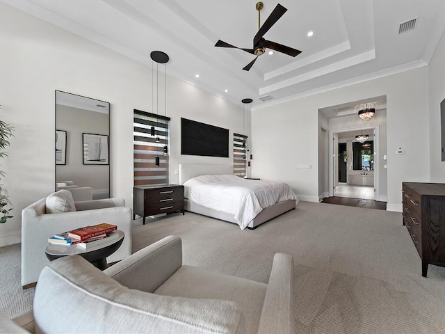 bedroom with carpet floors, ceiling fan, and a tray ceiling