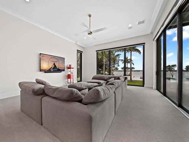 living room with crown molding, light colored carpet, and ceiling fan