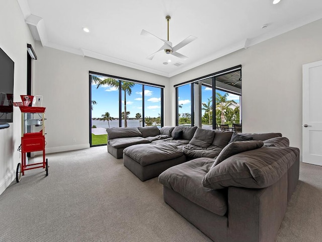 living room featuring ornamental molding, ceiling fan, and carpet flooring