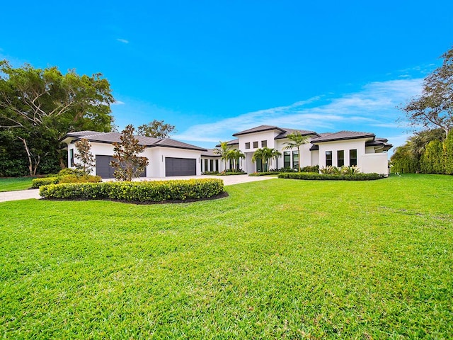 view of front of property with a garage and a front lawn