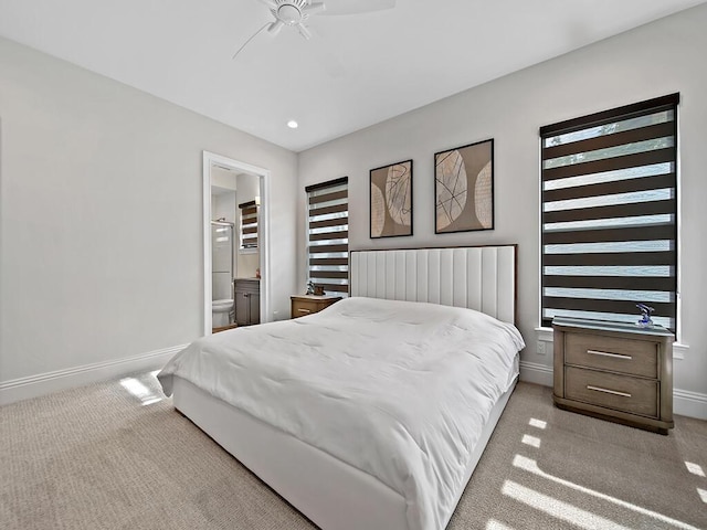 carpeted bedroom featuring ensuite bathroom and ceiling fan