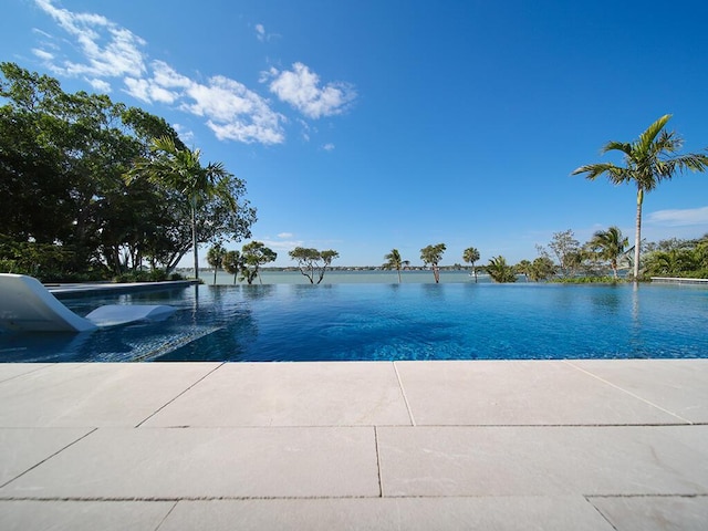 view of swimming pool with a water view