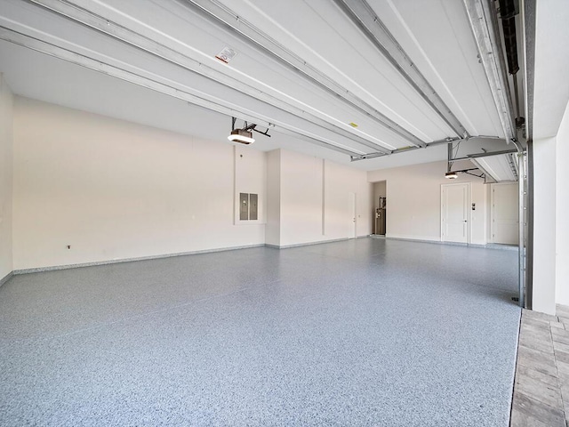 garage featuring a garage door opener and electric panel