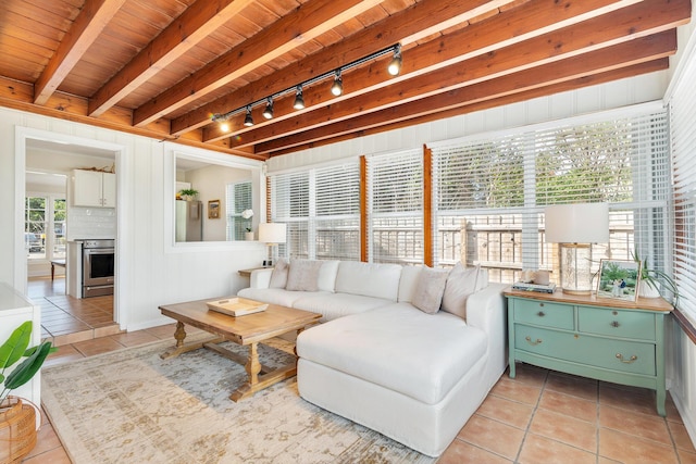 tiled living room with wood ceiling, rail lighting, and beamed ceiling